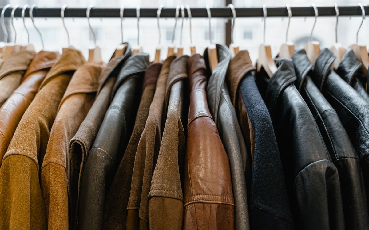Rack of leather jackets hanging neatly inside a boutique
