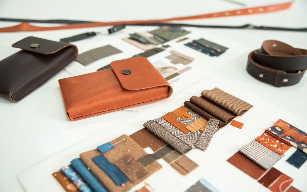 Colorful, finely worked leather goods on an artisan's table