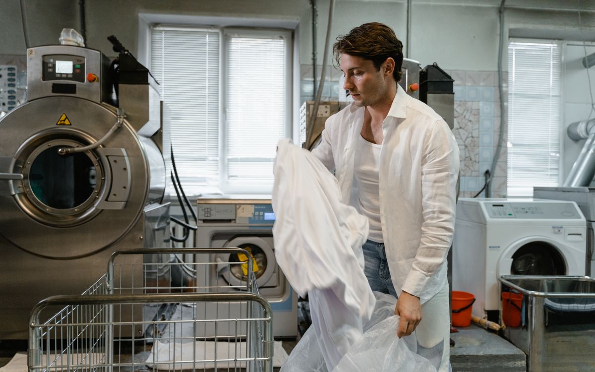 Garments on a rail inside a professional cleaning shop