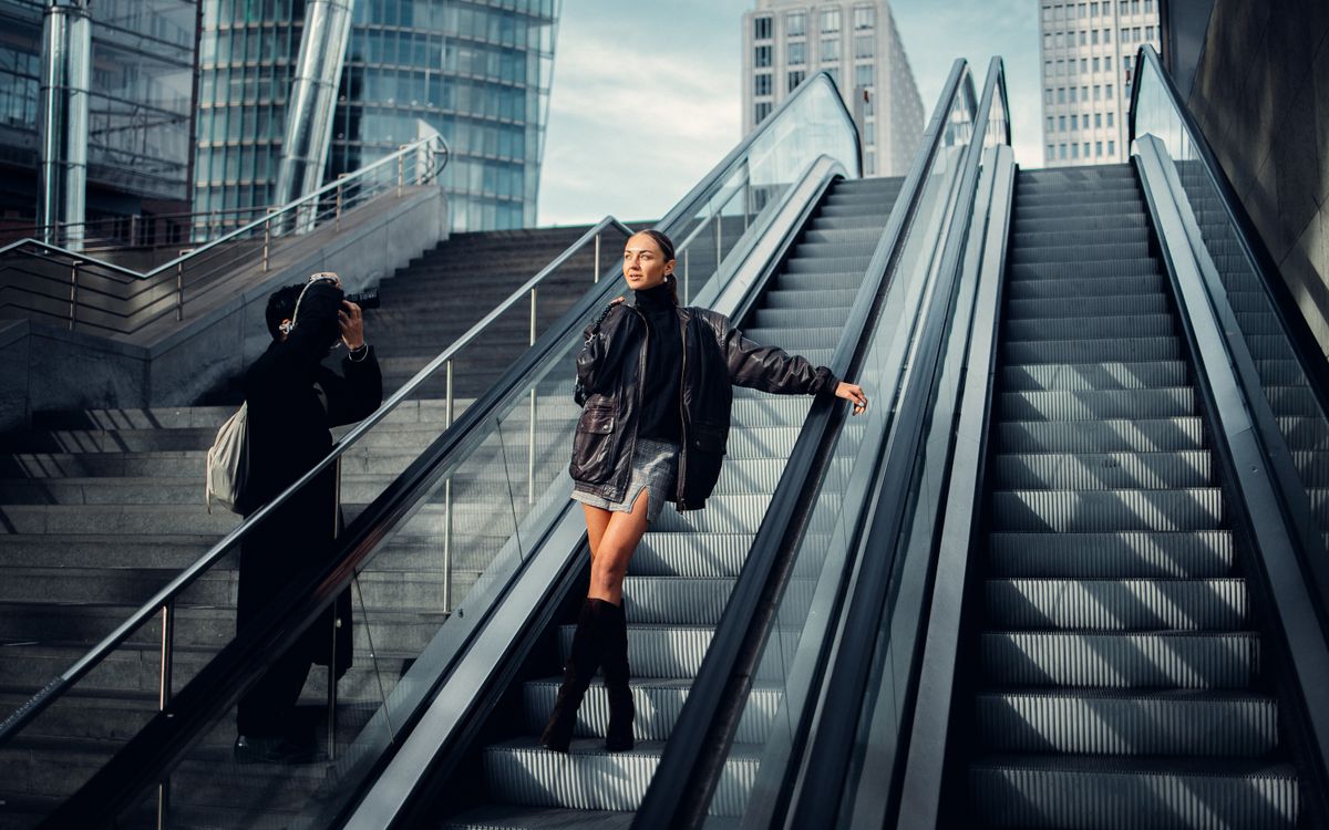 A stylish woman in an urban setting wearing a leather jacket outfit