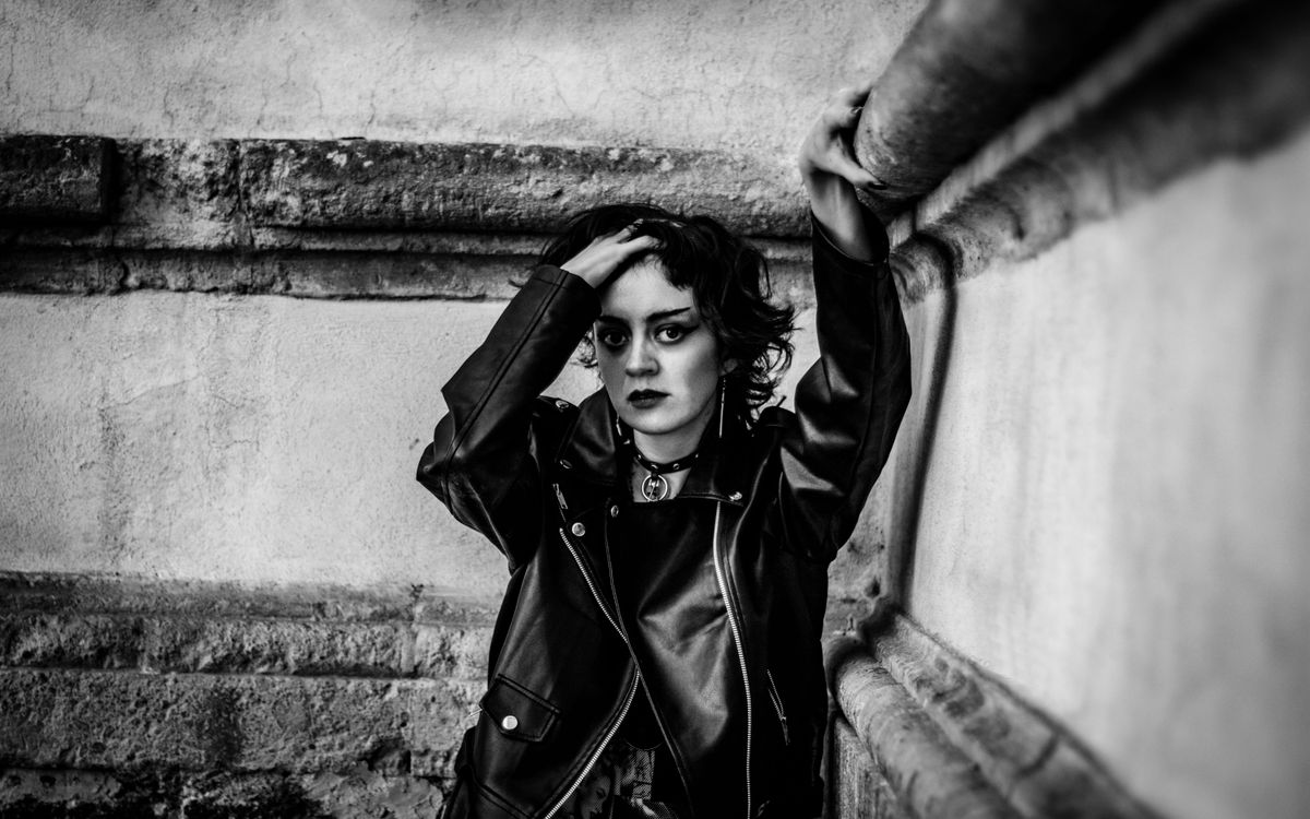 A person in a black leather jacket, moody portrait