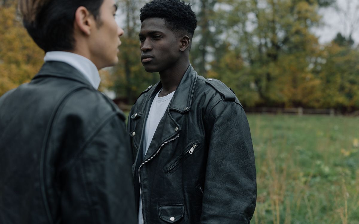 Two fashionable men wearing leather jackets outdoors